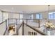 Spacious second floor hallway with a view of the kitchen and a modern chandelier at 6493 W 98Th Ct, Westminster, CO 80021