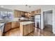 Modern kitchen featuring granite countertops, stainless steel appliances and a center island at 6493 W 98Th Ct, Westminster, CO 80021