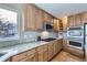 Bright kitchen featuring granite countertops, stainless steel appliances and wood cabinets at 6493 W 98Th Ct, Westminster, CO 80021