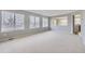 Bright living room featuring neutral paint, plush carpet, and large windows with natural light at 6493 W 98Th Ct, Westminster, CO 80021