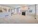 Inviting living room with a classic fireplace, a large window, and neutral carpet flooring at 6493 W 98Th Ct, Westminster, CO 80021