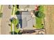 Aerial view of home showcasing roof, backyard, patio, mature landscaping and neighborhood street at 12400 Village Cir, Brighton, CO 80603