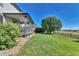 The lush backyard has a lawn and a view of the surrounding landscape at 12400 Village Cir, Brighton, CO 80603