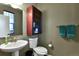 Cozy half bathroom with stylish fixtures, cabinet, and a decorative towel rack at 12400 Village Cir, Brighton, CO 80603