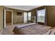Spacious bedroom with neutral walls, carpet, a vanity, and a window offering great light at 12400 Village Cir, Brighton, CO 80603