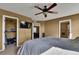 Primary bedroom showing a walk-in closet and en-suite bathroom at 12400 Village Cir, Brighton, CO 80603