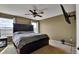 Comfortable bedroom featuring a large bed, ceiling fan, and natural light at 12400 Village Cir, Brighton, CO 80603