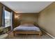 Simple bedroom with neutral walls, carpet, and a cozy bed illuminated by natural light at 12400 Village Cir, Brighton, CO 80603