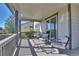 Covered deck with patio furniture and views at 12400 Village Cir, Brighton, CO 80603