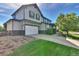 Exterior of home features a two-car garage and well-maintained landscaping at 12400 Village Cir, Brighton, CO 80603