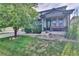 Well-maintained lawn and landscaping leading up to the charming covered front porch at 12400 Village Cir, Brighton, CO 80603