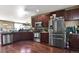 Well-equipped kitchen with stainless steel appliances, granite countertops, and hardwood floors, offering a sleek design at 12400 Village Cir, Brighton, CO 80603