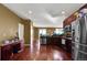 Modern kitchen with stainless steel appliances, dark wood cabinets, and hardwood floors throughout the house at 12400 Village Cir, Brighton, CO 80603