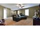 Upstairs living room with a large sectional and neutral carpet flooring at 12400 Village Cir, Brighton, CO 80603