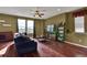 Comfortable living room with wood flooring and a cozy couch at 12400 Village Cir, Brighton, CO 80603