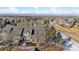 Wide aerial view of homes and landscape; showcasing the community and mountain views at 6415 Trailhead Rd, Highlands Ranch, CO 80130