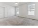 Spacious carpeted bedroom with double door closet and large windows at 6415 Trailhead Rd, Highlands Ranch, CO 80130