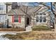 House exterior with stone, red shutters, and landscaping at 6415 Trailhead Rd, Highlands Ranch, CO 80130