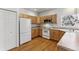 Galley-style kitchen with light wood cabinets and appliances at 6415 Trailhead Rd, Highlands Ranch, CO 80130