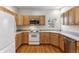 Efficient kitchen featuring wood cabinets and appliances at 6415 Trailhead Rd, Highlands Ranch, CO 80130
