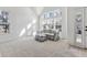 Sunlit living area with a comfy couch and ottoman at 6415 Trailhead Rd, Highlands Ranch, CO 80130