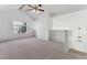 Open living room with vaulted ceiling, carpet and large windows at 6415 Trailhead Rd, Highlands Ranch, CO 80130