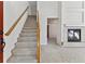 Bright entryway with carpeted staircase and fireplace at 6415 Trailhead Rd, Highlands Ranch, CO 80130