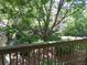 Balcony view overlooking a lush courtyard with mature trees and landscaping at 14740 E Kentucky Dr # 725, Aurora, CO 80012