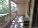 Cozy balcony with neutral siding, a small window air conditioner, and a view of the trees at 14740 E Kentucky Dr # 725, Aurora, CO 80012