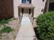 Pathway to a residential entrance with a ramp, flanked by landscaping at 14740 E Kentucky Dr # 725, Aurora, CO 80012
