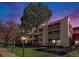 Exterior view of a condo building with multiple balconies and a large tree in the foreground at 14740 E Kentucky Dr # 725, Aurora, CO 80012