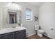 Charming bathroom with gray vanity, decorative mirror, and neutral wall color at 19247 E Gunnison Pl # 104, Aurora, CO 80017