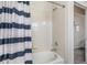 Bathroom featuring a tiled bathtub with a striped curtain, and a shower head at 19247 E Gunnison Pl # 104, Aurora, CO 80017