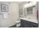 Bathroom featuring modern sink, vanity, mirror, tile flooring and framed art at 19247 E Gunnison Pl # 104, Aurora, CO 80017