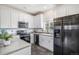 Modern kitchen with stainless steel appliances, white cabinets, and ample counter space at 19247 E Gunnison Pl # 104, Aurora, CO 80017