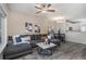 Inviting living room features a comfortable sectional, ceiling fan, and eat in kitchen at 19247 E Gunnison Pl # 104, Aurora, CO 80017