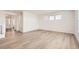 Bright, open living room with wood floors and plenty of natural light from large windows at 627 Nightsky St, Erie, CO 80516