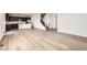 Spacious living area with wood floors, seamlessly connected to the kitchen and staircase at 627 Nightsky St, Erie, CO 80516