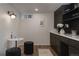 Finished basement wet bar area with dark cabinetry and light countertops at 768 W Larigo Ave, Littleton, CO 80120