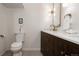 Modern bathroom featuring a dual sink vanity with gold hardware and a framed mirror at 768 W Larigo Ave, Littleton, CO 80120