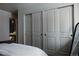 Neutral bedroom showcasing built in closets, soft carpets and ensuite bathroom at 768 W Larigo Ave, Littleton, CO 80120