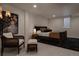 Inviting bedroom with a cozy chair, modern lighting, and a large area rug at 768 W Larigo Ave, Littleton, CO 80120