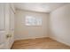 Neutral bedroom features hardwood floors, a closet and a window providing natural light at 768 W Larigo Ave, Littleton, CO 80120