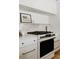 Close up of a modern, well-equipped kitchen featuring a gas range, marble countertops, and stainless steel accents at 768 W Larigo Ave, Littleton, CO 80120