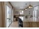 Kitchen with island, marble countertops, stylish lighting, breakfast nook and sliding glass doors at 768 W Larigo Ave, Littleton, CO 80120