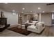 Spacious living room featuring recessed lighting, sleek flooring, modern furniture, and a striking fireplace at 768 W Larigo Ave, Littleton, CO 80120