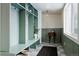 Mudroom with a custom storage unit, wainscoting and natural light at 768 W Larigo Ave, Littleton, CO 80120