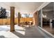 Covered patio featuring stylish outdoor furniture and an open view into the dining area at 768 W Larigo Ave, Littleton, CO 80120