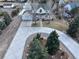 Aerial view of a home with an expansive driveway and mature trees, in a well-maintained neighborhood at 7440 W 94Th Pl, Westminster, CO 80021