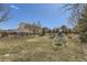 Spacious backyard featuring a playground, wooden fence, and mature trees, perfect for outdoor activities at 7440 W 94Th Pl, Westminster, CO 80021